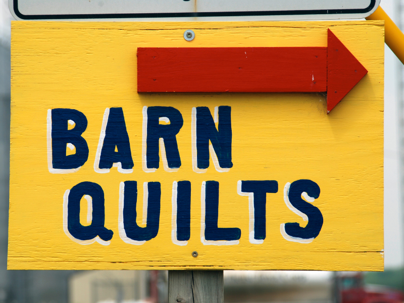 barn quilt sign with arrow