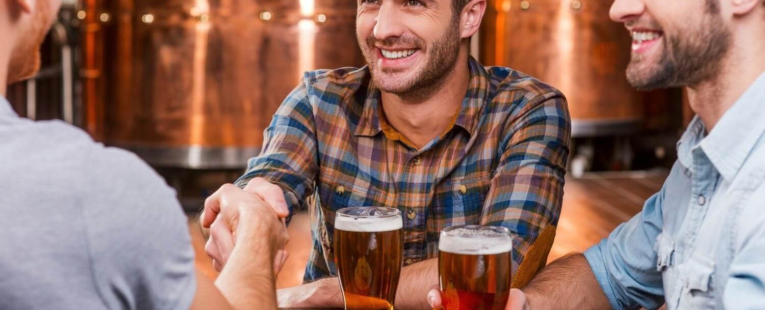 Guys sitting at brewery