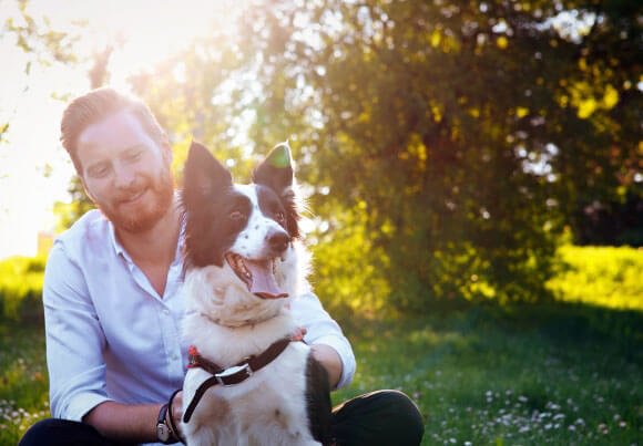 man sitting with dog