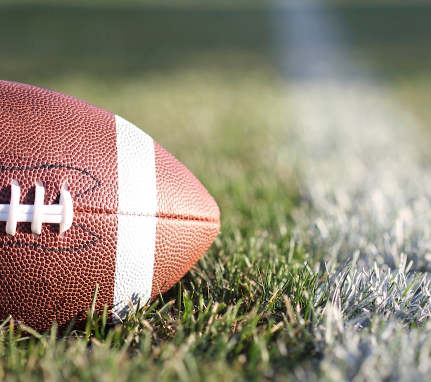 American Football on field with yard line and green grass