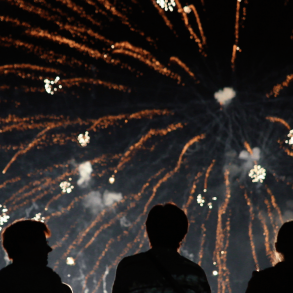 People watching fireworks in the nighttime sky