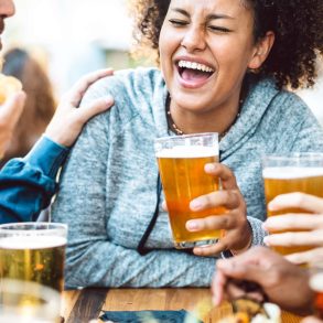 A group of happy people drinking beer at a brewery