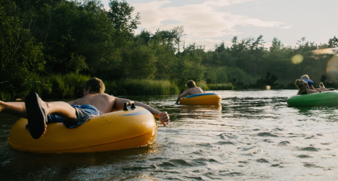 group of people tubing on river