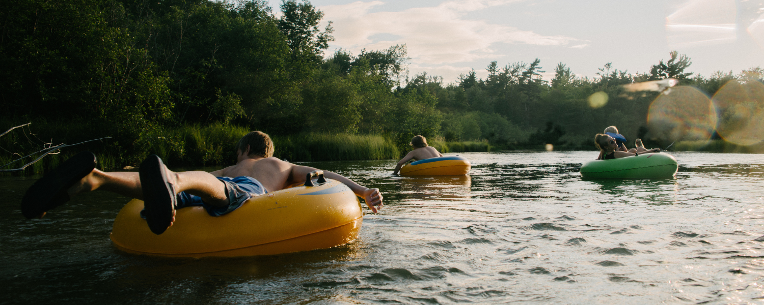 group of people tubing on river