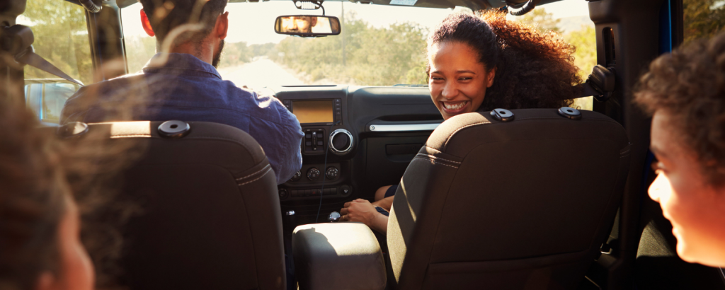 family in car on road trip