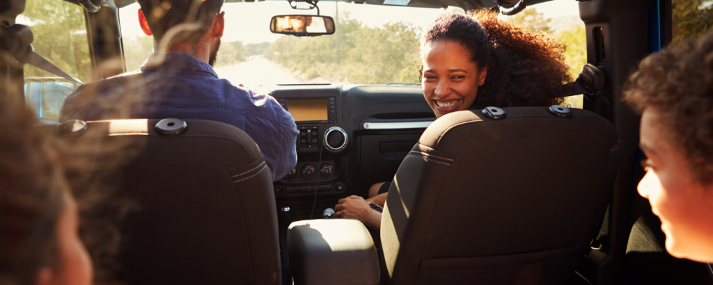 family in four in jeep on road trip