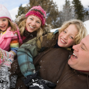 family playing in snow