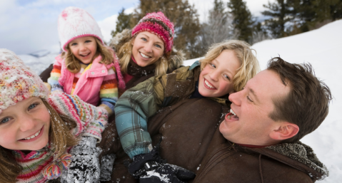 family playing in snow