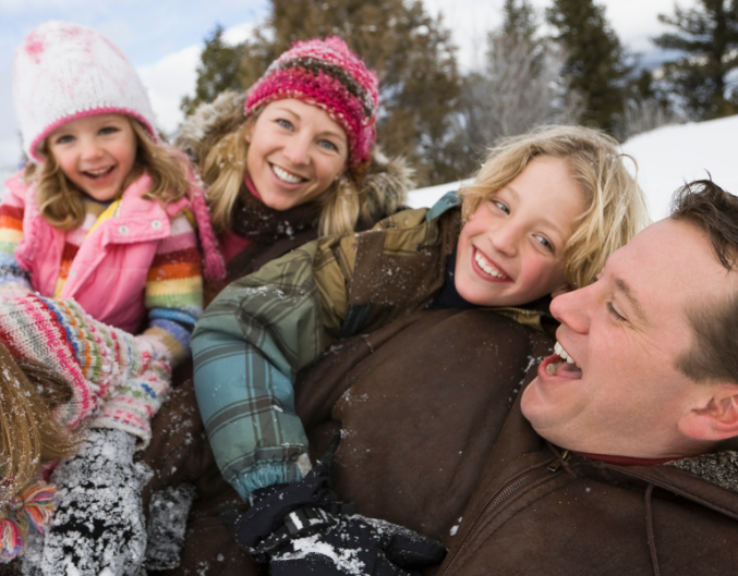 family playing in snow