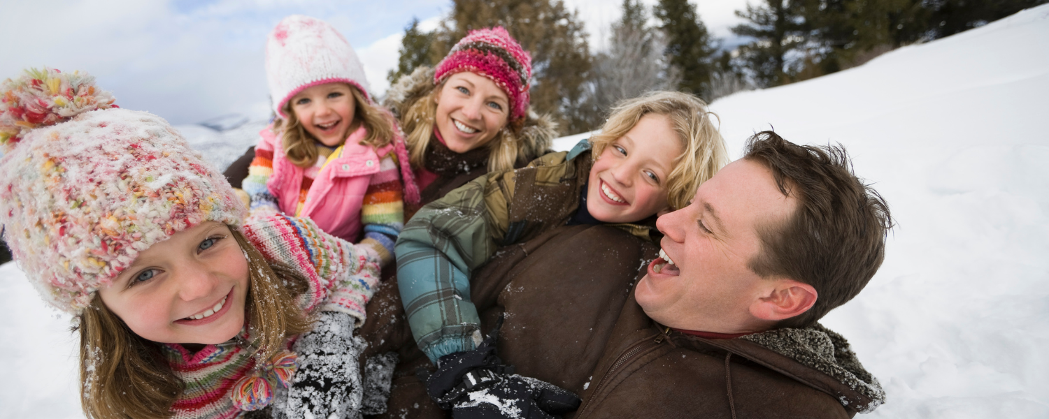 family playing in snow