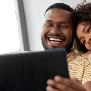 couples smiling and looking at iPad together