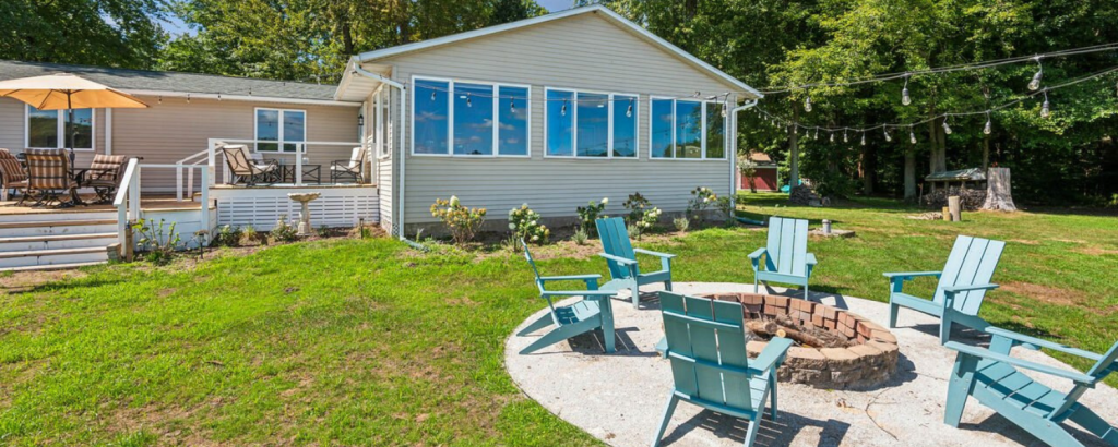 vacation rental exterior with blue chairs and fire pit