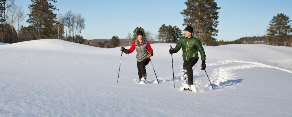 man and woman cross-country skiing