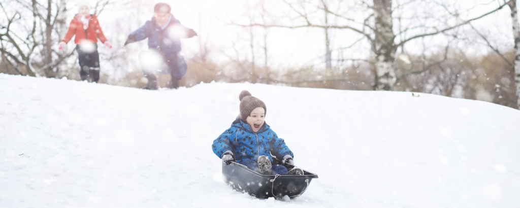 small child sledding