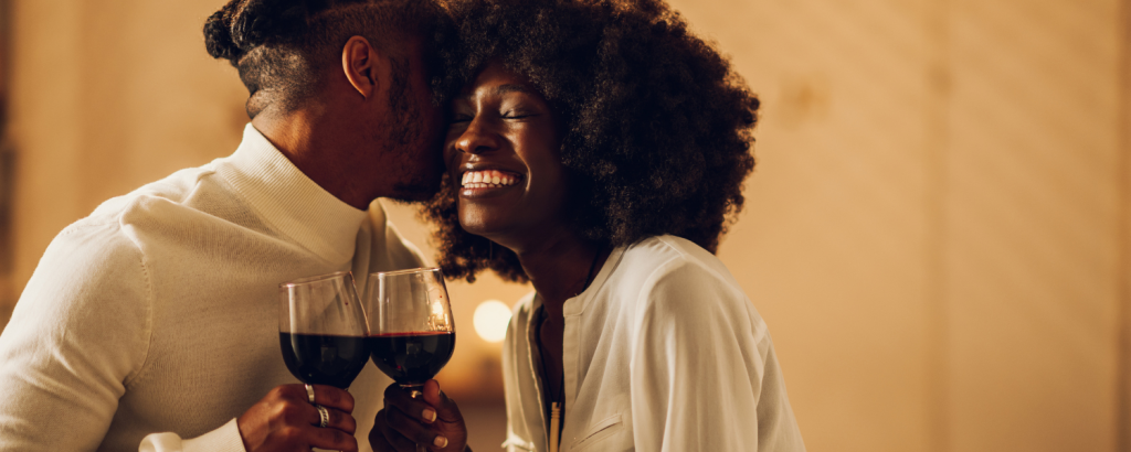 couple laughing and drinking wine