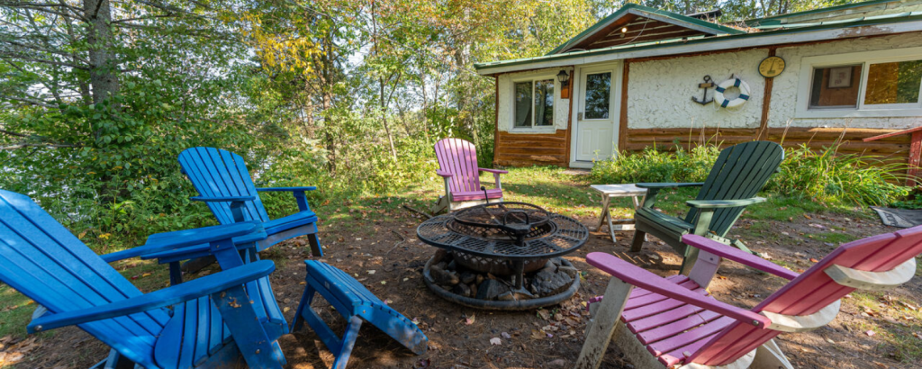 front lawn of vacation rental with chairs and fire pit