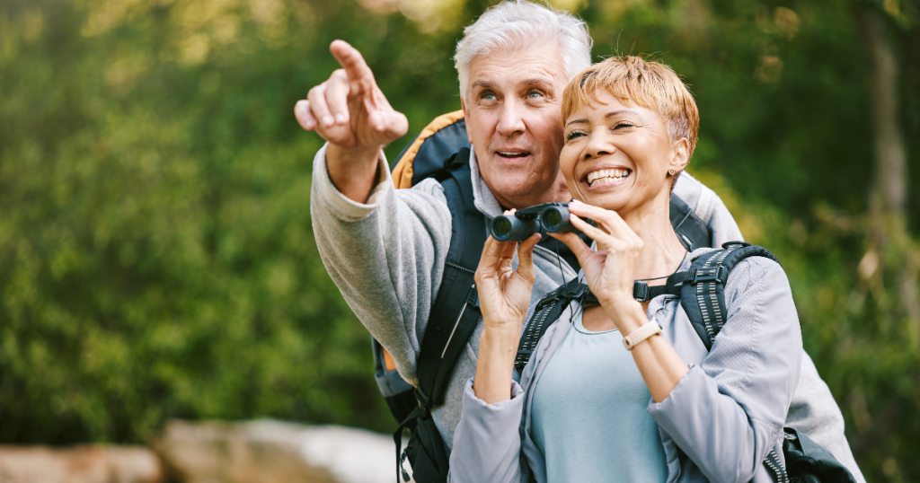 couple with binoculars during hike