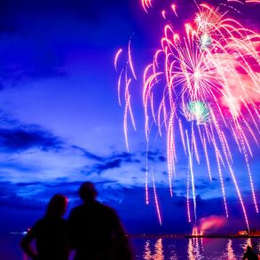 Fireworks over Lake Michigan at dusk.