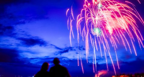 Fireworks over Lake Michigan at dusk.