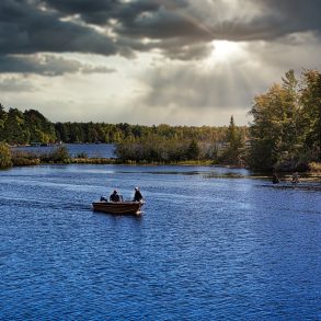Fishermen in fishing boat on lake in Michigan.