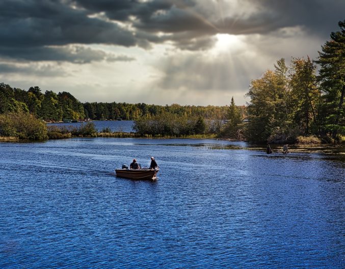 Fishermen in fishing boat on lake in Michigan.