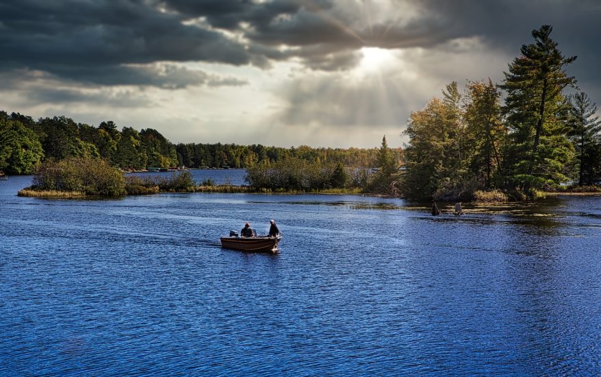 Fishermen in fishing boat on lake in Michigan.