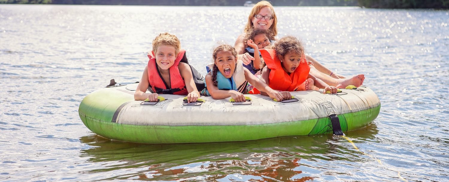 Smiling family tubing on an inland lake