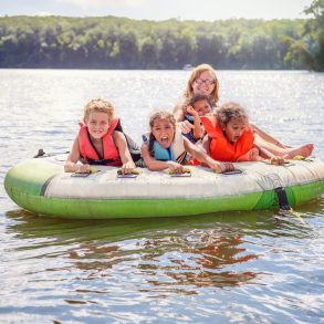 Smiling family tubing on an inland lake